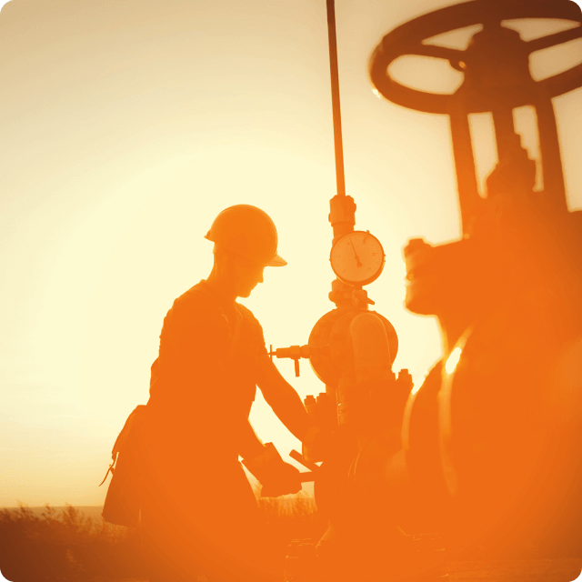 Oil worker at sunset