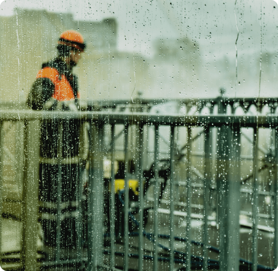 A man working during the rain