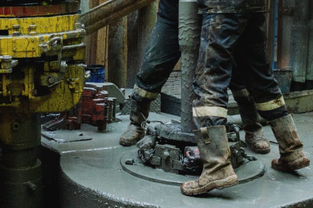 Workers demonstrating the effectiveness of proper safety shoes.