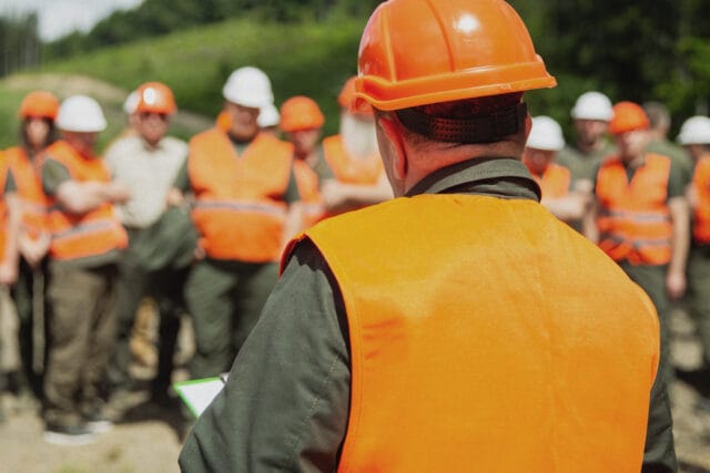 A safety trainer inspects a worksite.