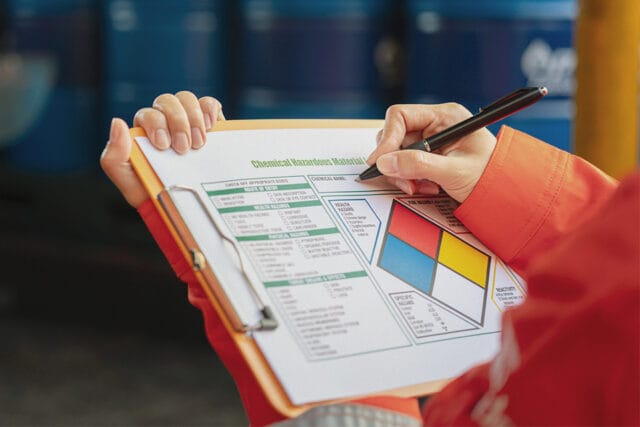 A worker on a job site uses a form as hazard communication channel.