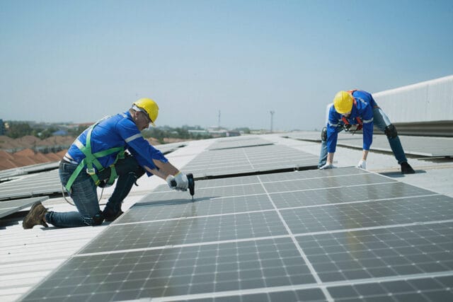 workers install solar panels for the utilities sector