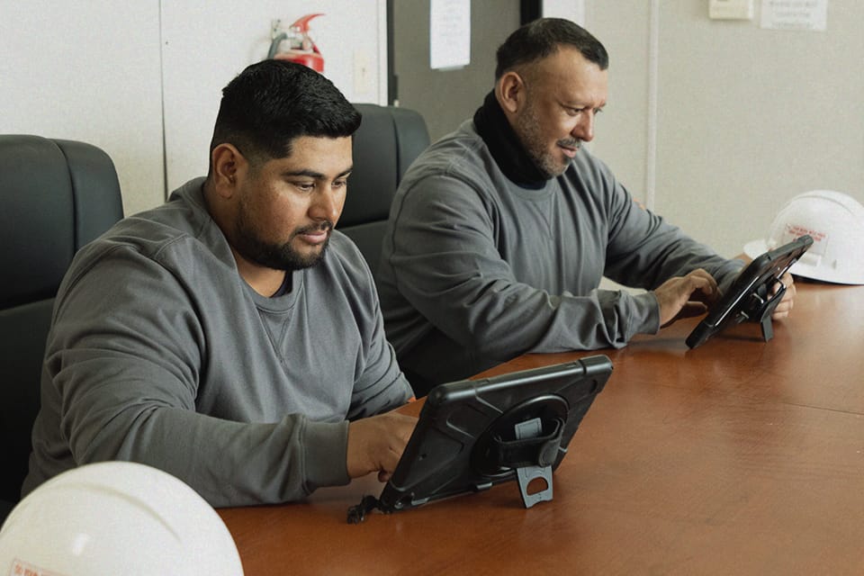 Workers attend a safety training course to increase workplace and workforce safety.